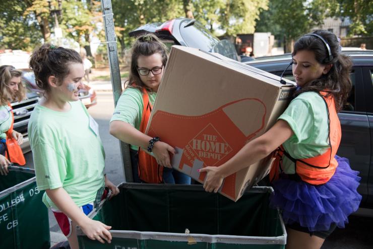 Two students helping incoming students move into residence halls