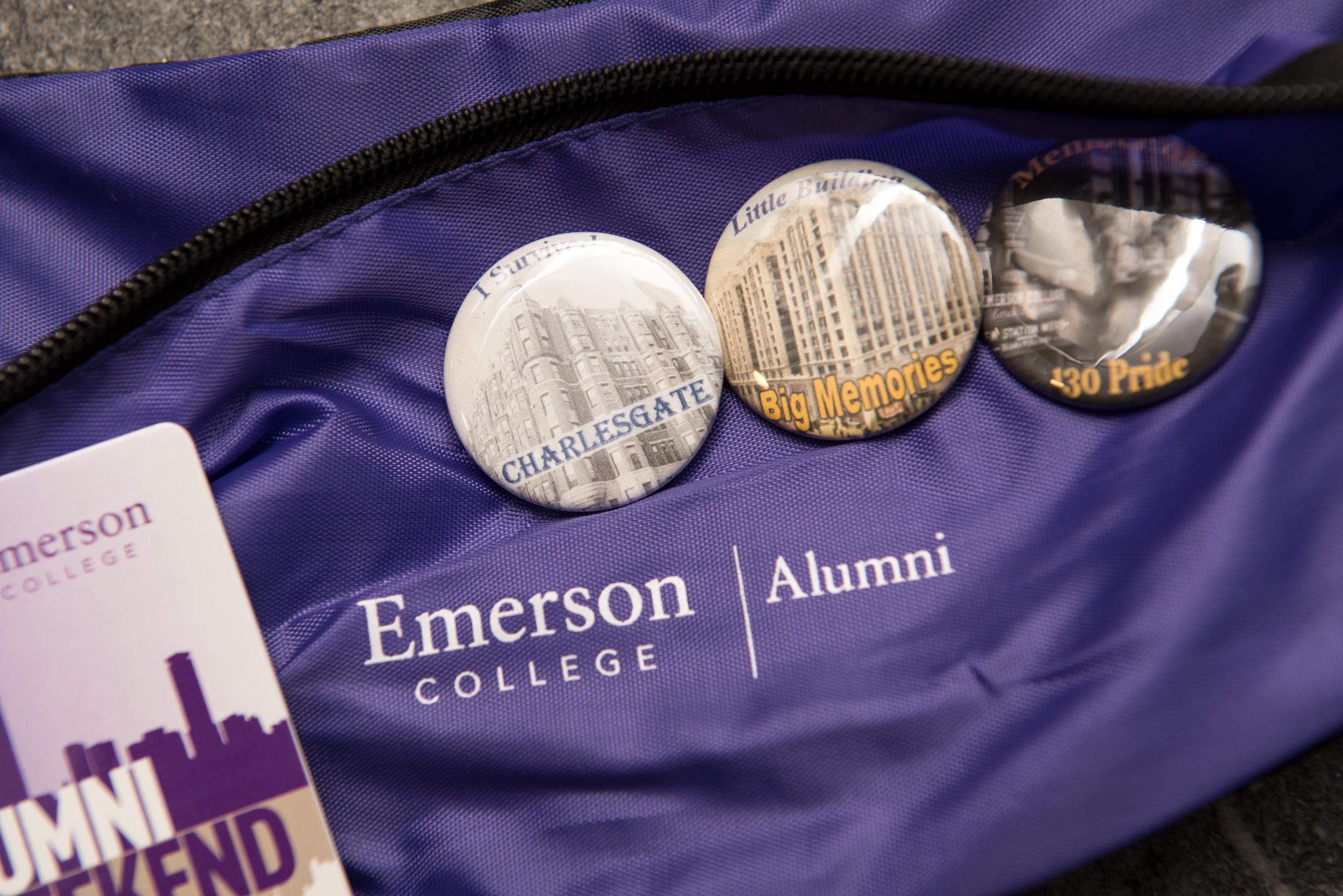 Zoomed-in shot of Emerson College Alumni bag with badges and tag placed on top