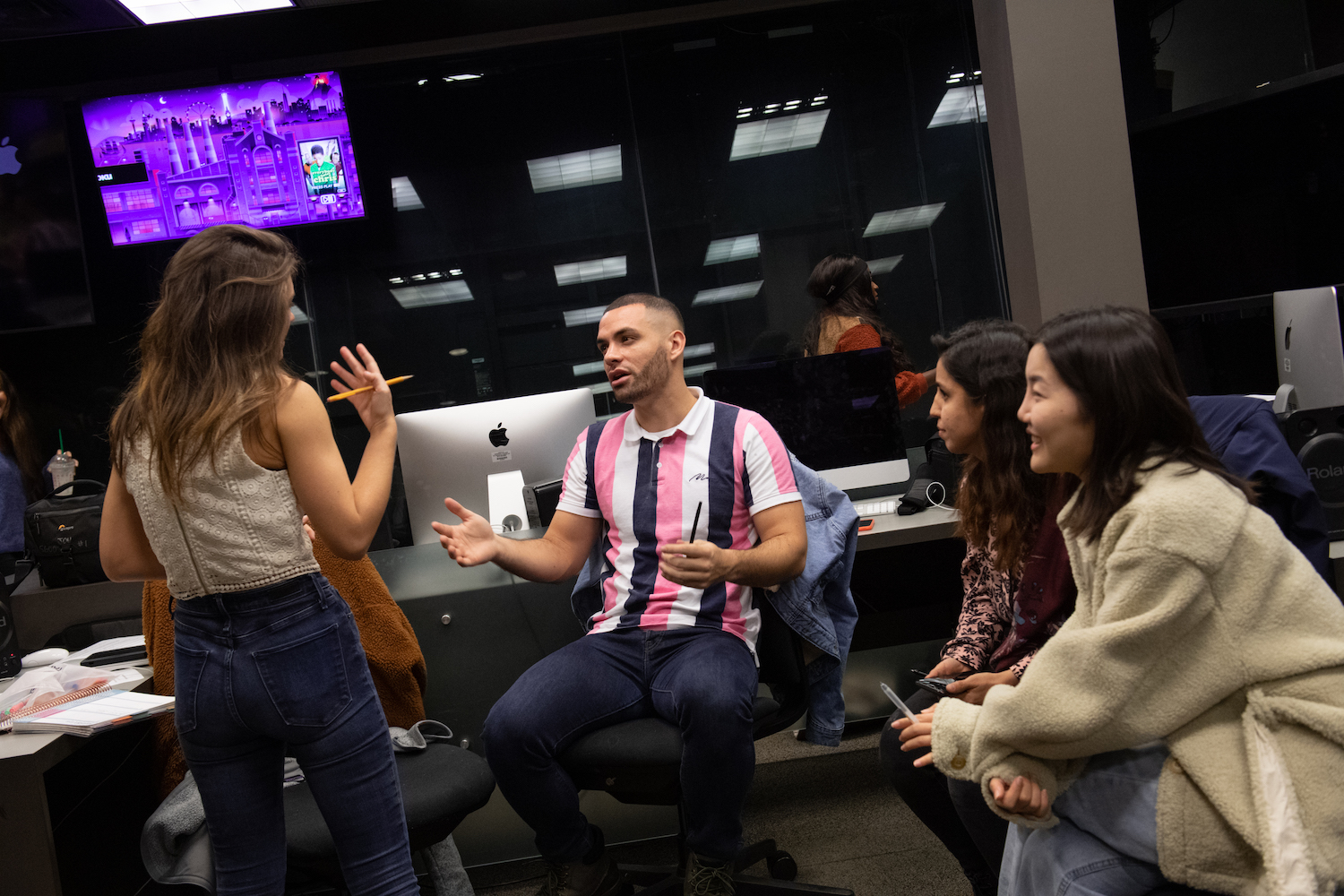 Paul Niwa, CJE Associate Professor, Journalism teaching graduate students about camera equipment