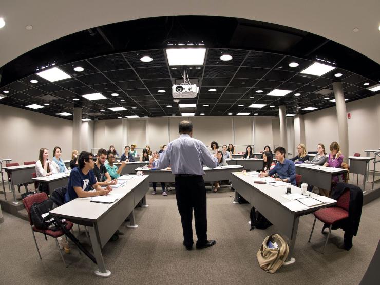 Image of faculty member speaking in a classroom