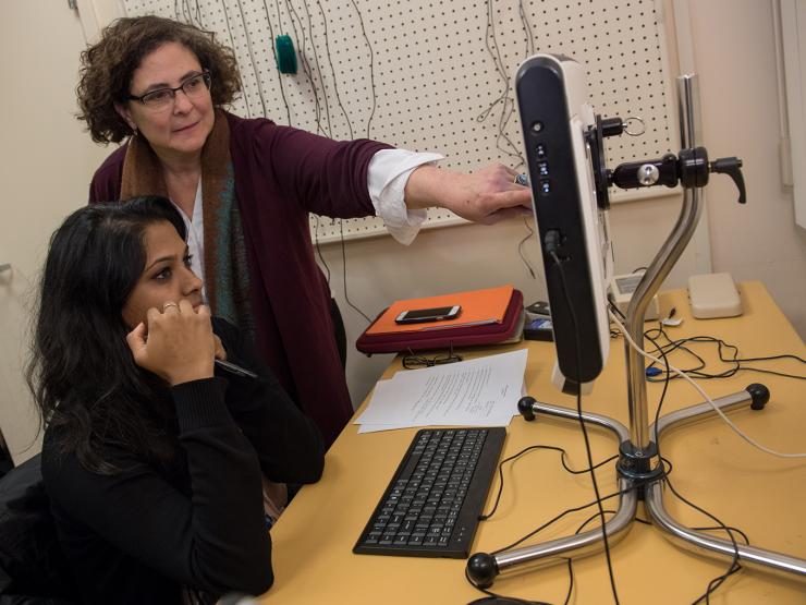 Professor instructing student in speech lab