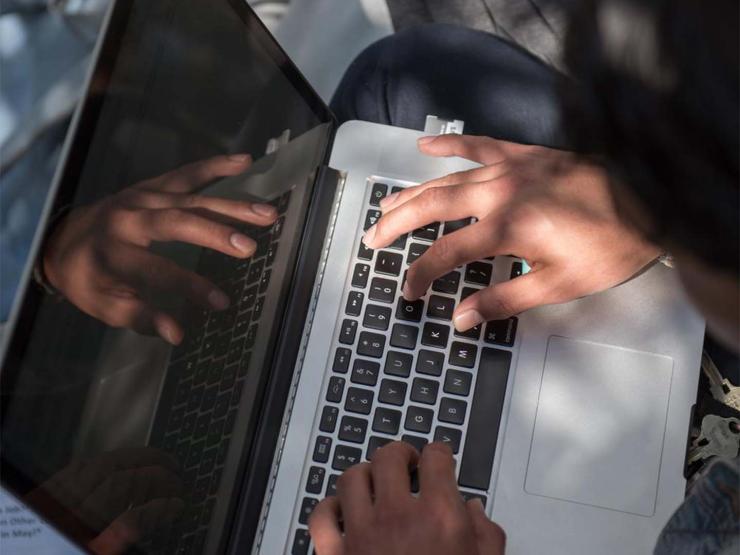 Close up of person working on laptop