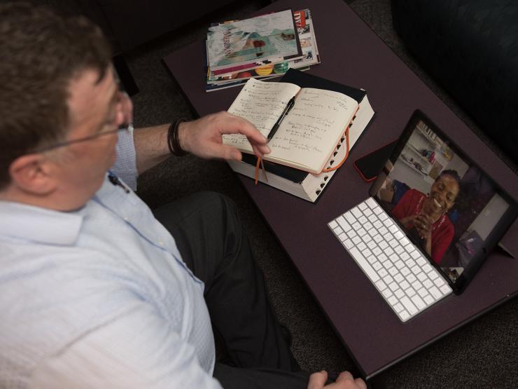 Student talking with professor over webcam