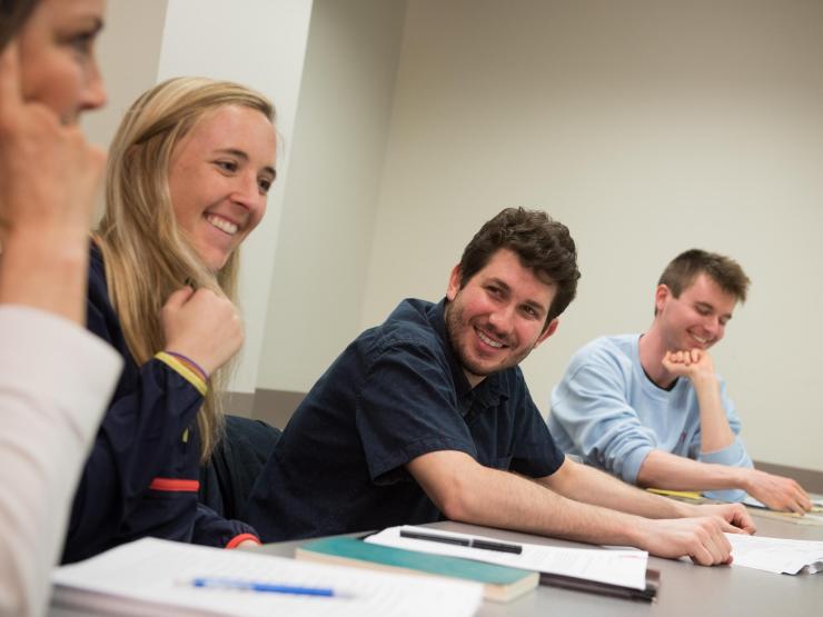Student smiling at other students in a class