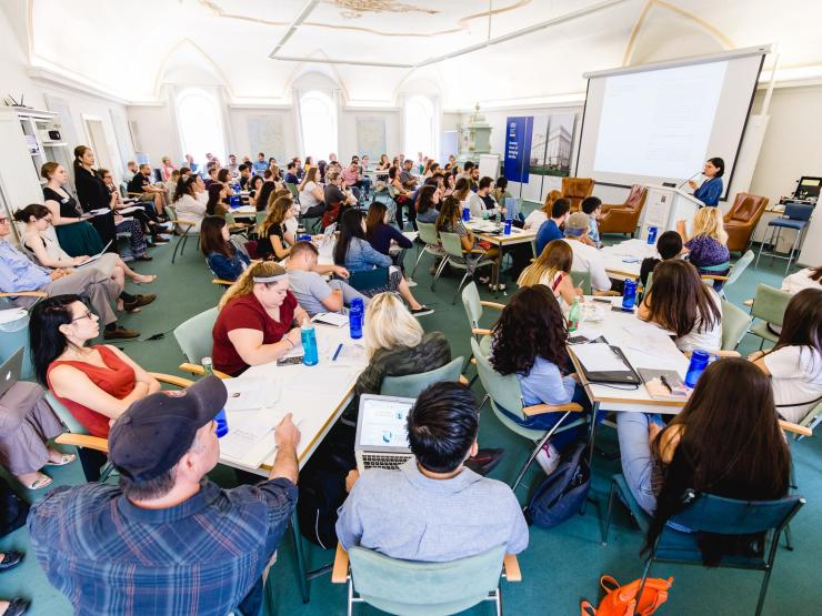 Students and faculty attending a session in a packed room