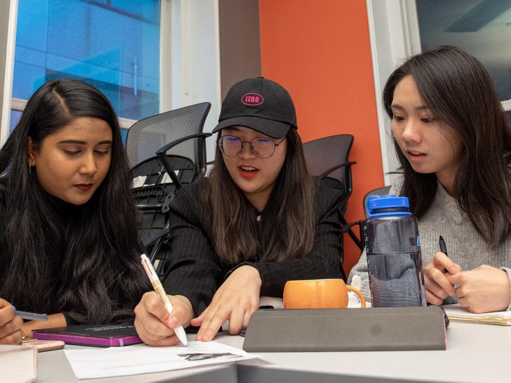 Graduate students collaborating at table