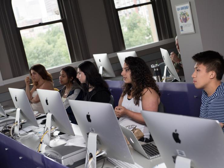 Students sitting behind computers