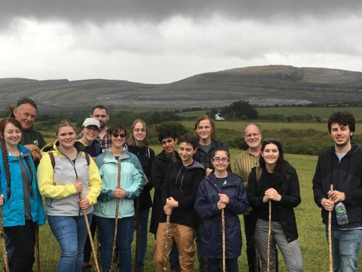 Students with professor standing outside on a hill in Ireland