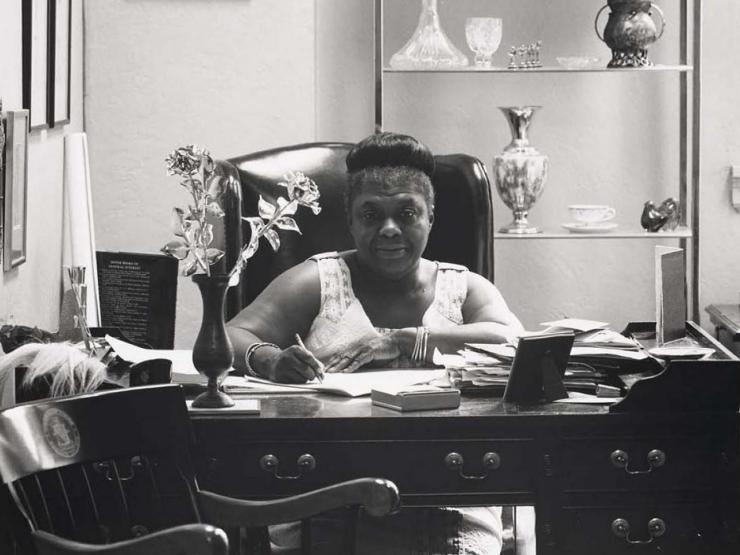 Black and white photo of Ms. Elma Lewis at desk