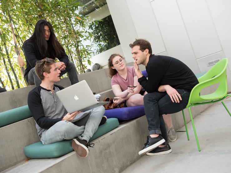 Four students sitting in a common area at Emerson Los Angeles chatting