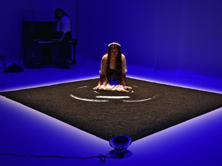 a lone student performing in a square area 