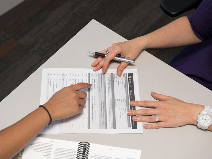 forms on table with hands pointing