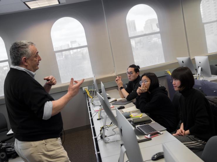 professor instructing students in a computer lab