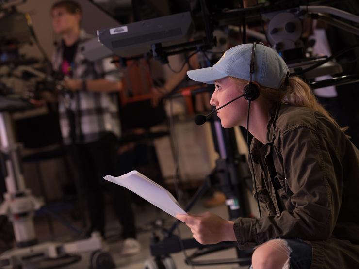 student wearing headset in a studio