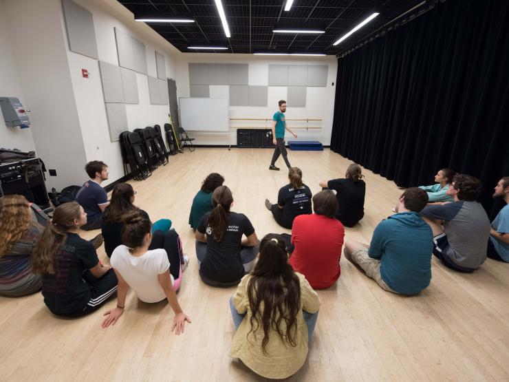 Instructor Matthew McMahan teaching an improv to a mixed group of students within a studio