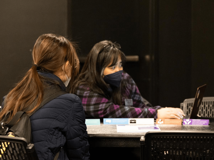 Two people at a desk at the career fair