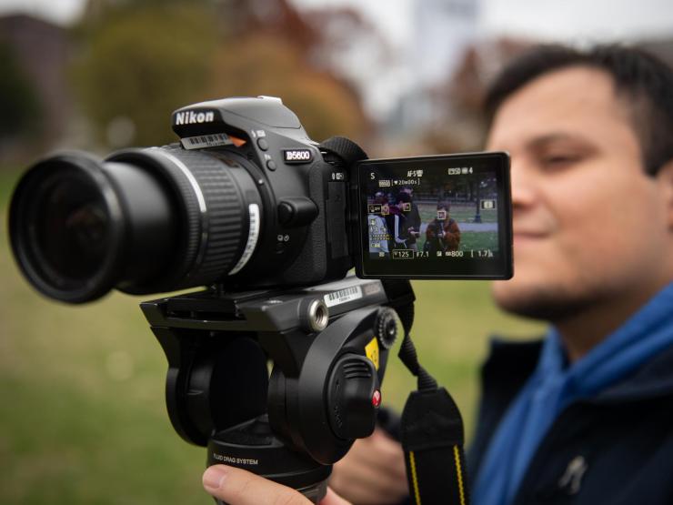 Emerson journalism student operating a camera
