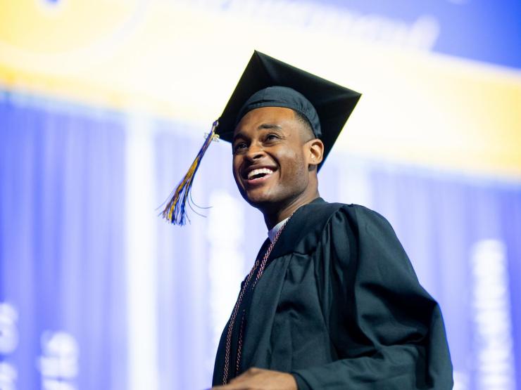 Portrait of students at graduation wearing cap and gown