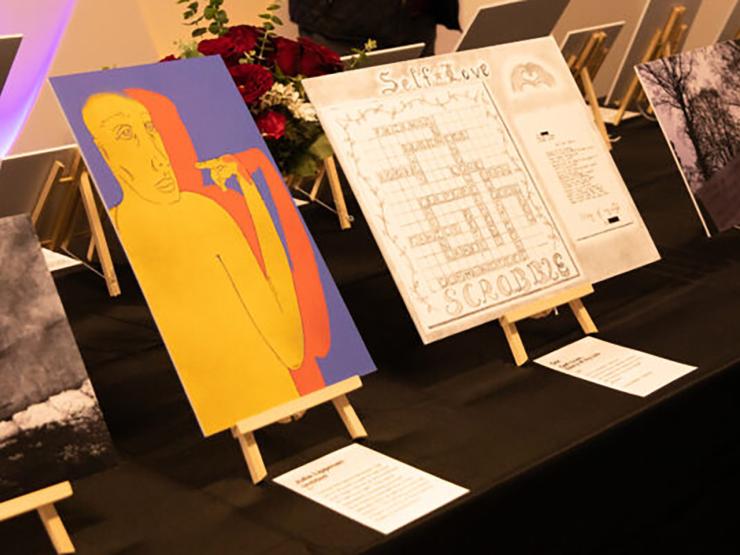A gallery exhibit of five different art pieces from the self-love gallery open house