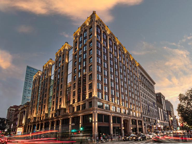 The Little Building, Emerson College's flagship campus building in Boston, standing brightly lit during dusk