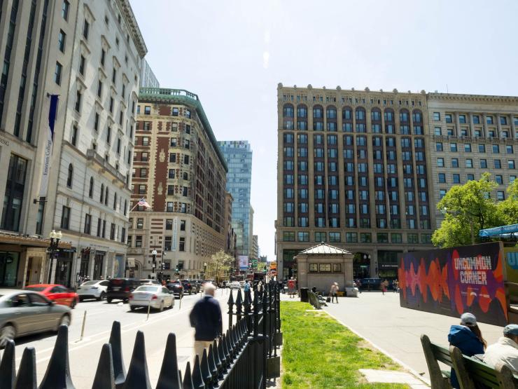 A view of the corner of Boylston and Tremont Streets in downtown Boston, with a sign for the Emerson College UnCommon Corner stage.