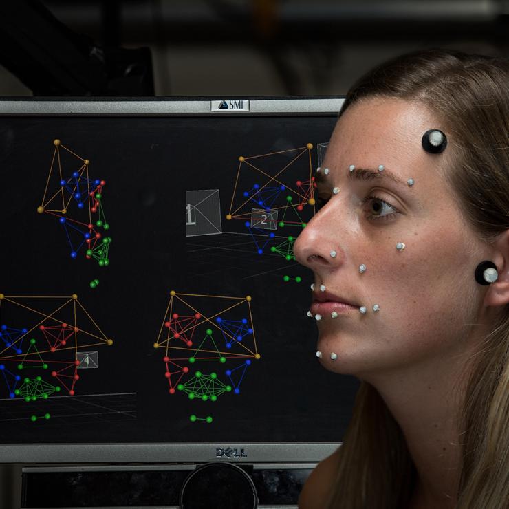 A student is outfitted with reflective markers in the FACE Lab. Researchers use infrared eye-tracking technology to capture the movements that create facial expressions, which helps them understand how people with autism spectrum disorders perceive and produce social cues.