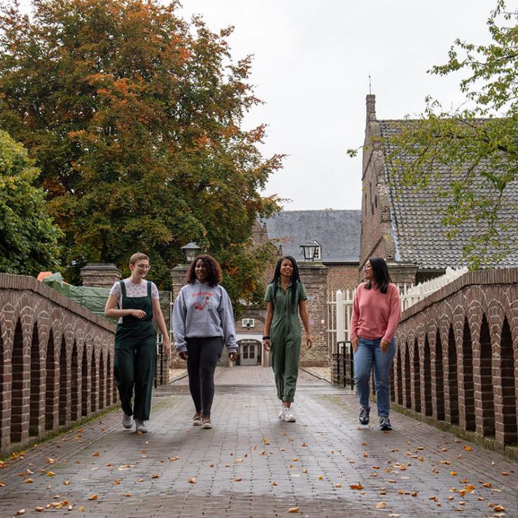 Students walking along a castle bridge