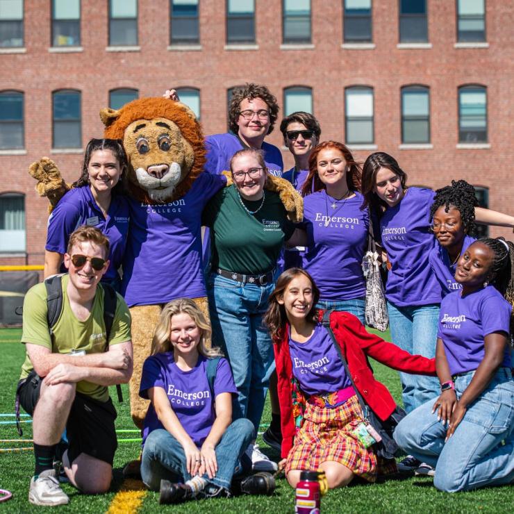 Emerson College mascot Griff takes a picture with students at Rotch Field, where Emerson sports teams compete