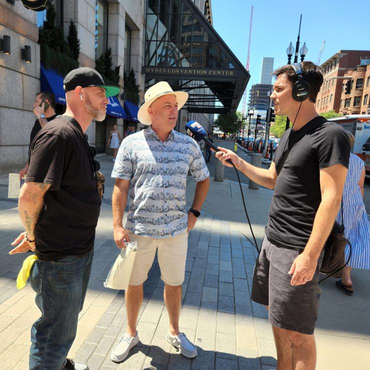Journalist Matt Shearer ’09, reporter for Boston’s WBZ NewsRadio, interviews people on the street outside Hynes Convention Center in downtown Boston.