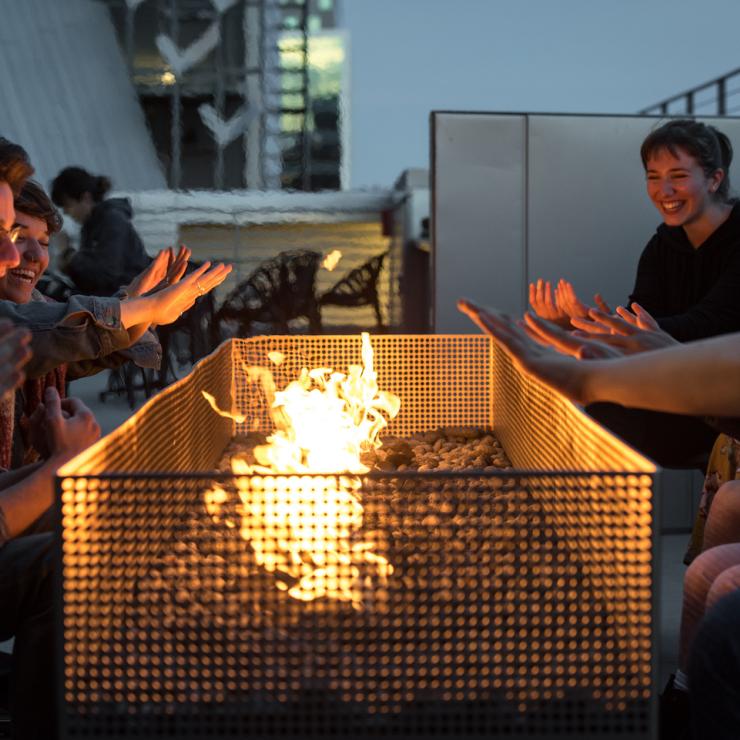 Emerson Los Angeles students sitting around bonfire on campus