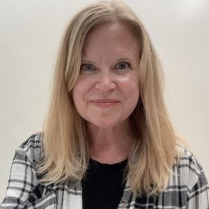 Gretchen Biesecker, a woman with long blonde hair wearing a plaid, black-and-white shirt