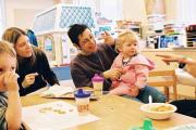 A room of adults playing with children at the Robbins Center