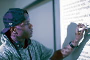 Person writing on whiteboard