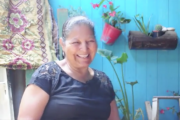 Person smiling at camera against blue background