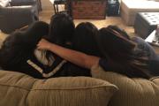 People on a couch, huddled together