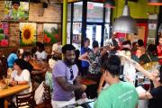 Person placing an order in a crowded cafe