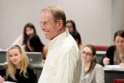 Faculty member smiling in a classroom of students