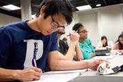 Students writing in notebooks