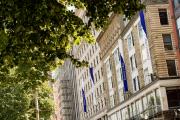 Buildings on Boylston Street with Emerson College banners, surrounded by trees