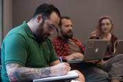 student and faculty members taking notes
