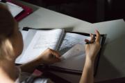 a woman flipping pages of a notebook