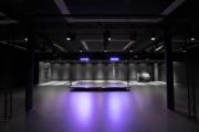 Interior shot of the Student Performance Center lit in purple