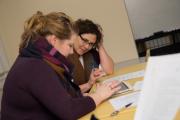 Faculty members helping each other with paperwork