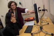 An instructor helping a student on a computer