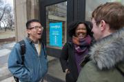 Three students laughing and talking