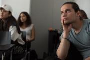 Students in classroom intently watching lecture from seats