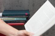 Side view of someone reading book