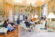 Students in discussion in a room in Salzburg
