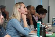 Faculty members listing to a speaker