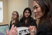 Group of students listing to a faculty member speak